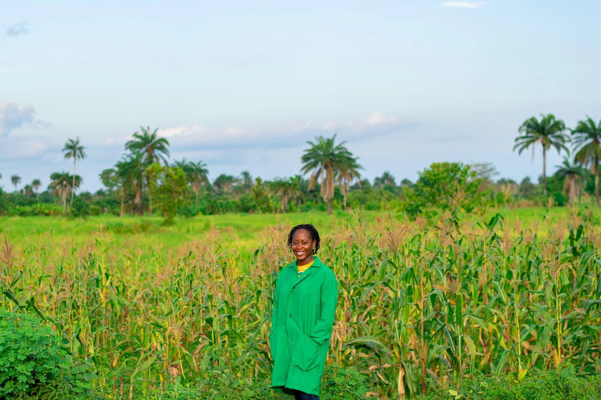 Farmer standing by farm